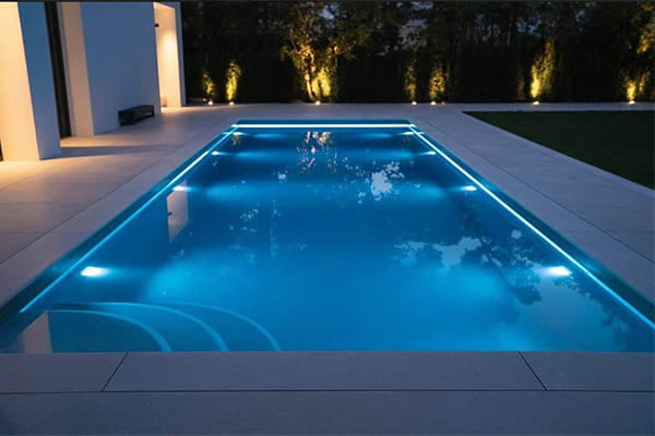 Layered lighting scheme for an outdoor pool area